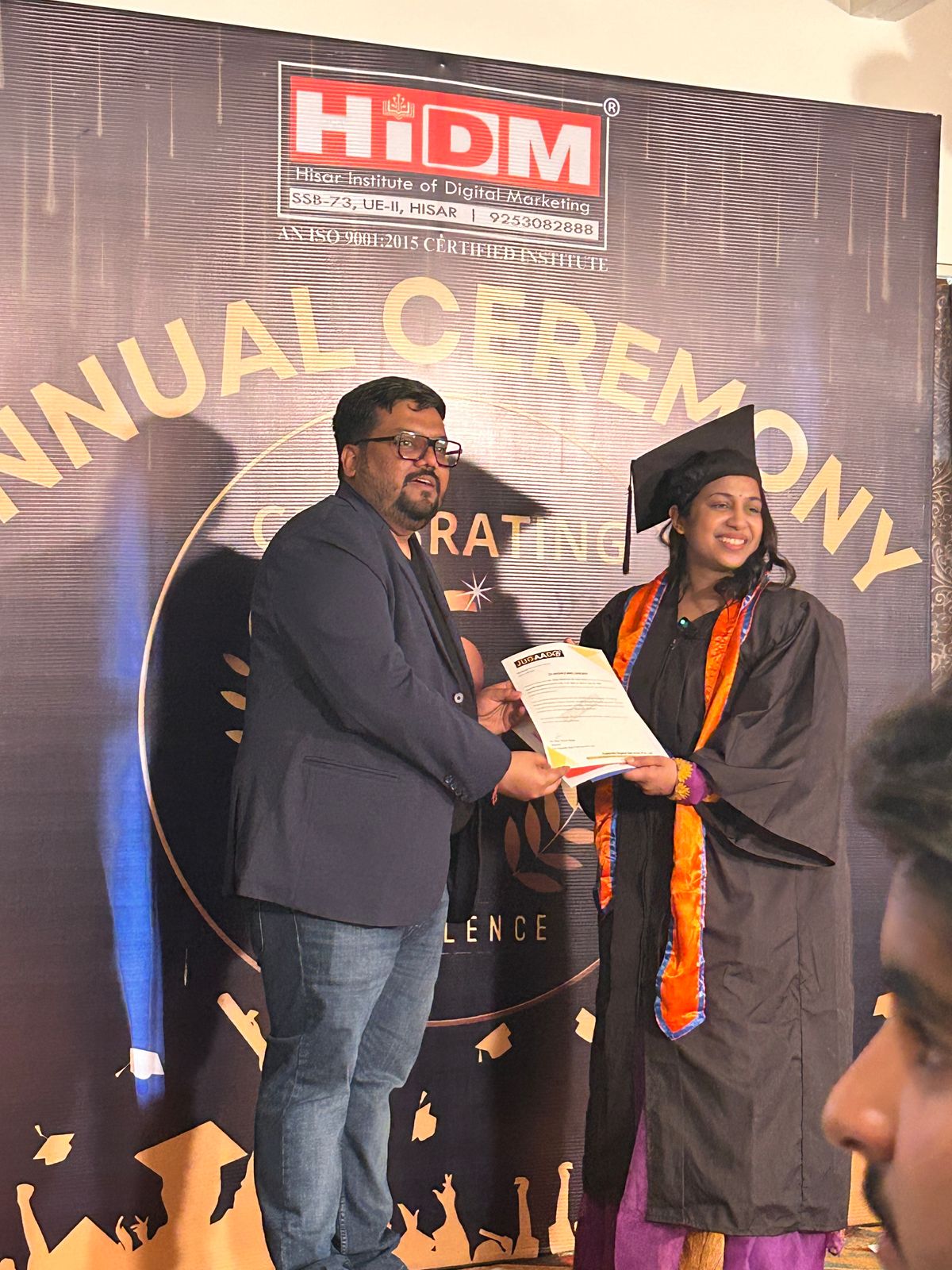 Student proudly holding certificate at HIDM’s Annual Ceremony.
