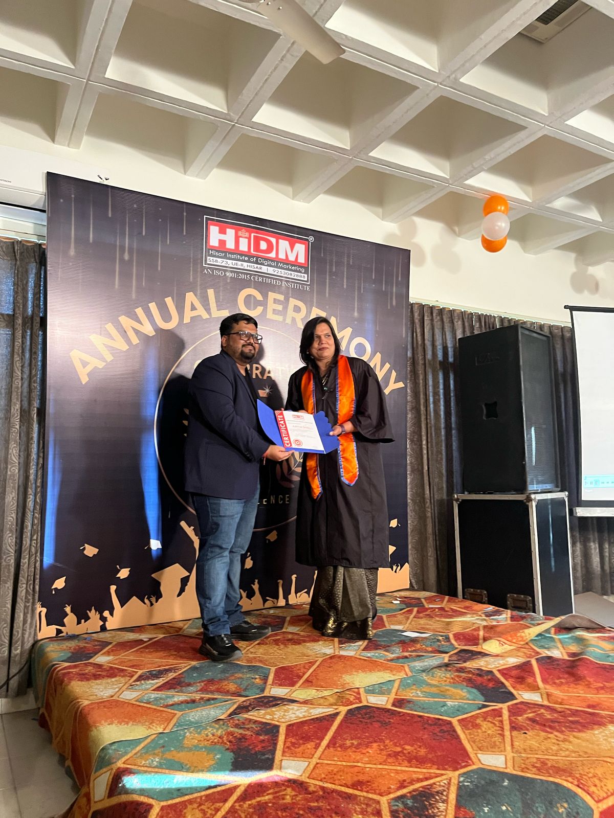 Happy student receiving certificate at HIDM event.