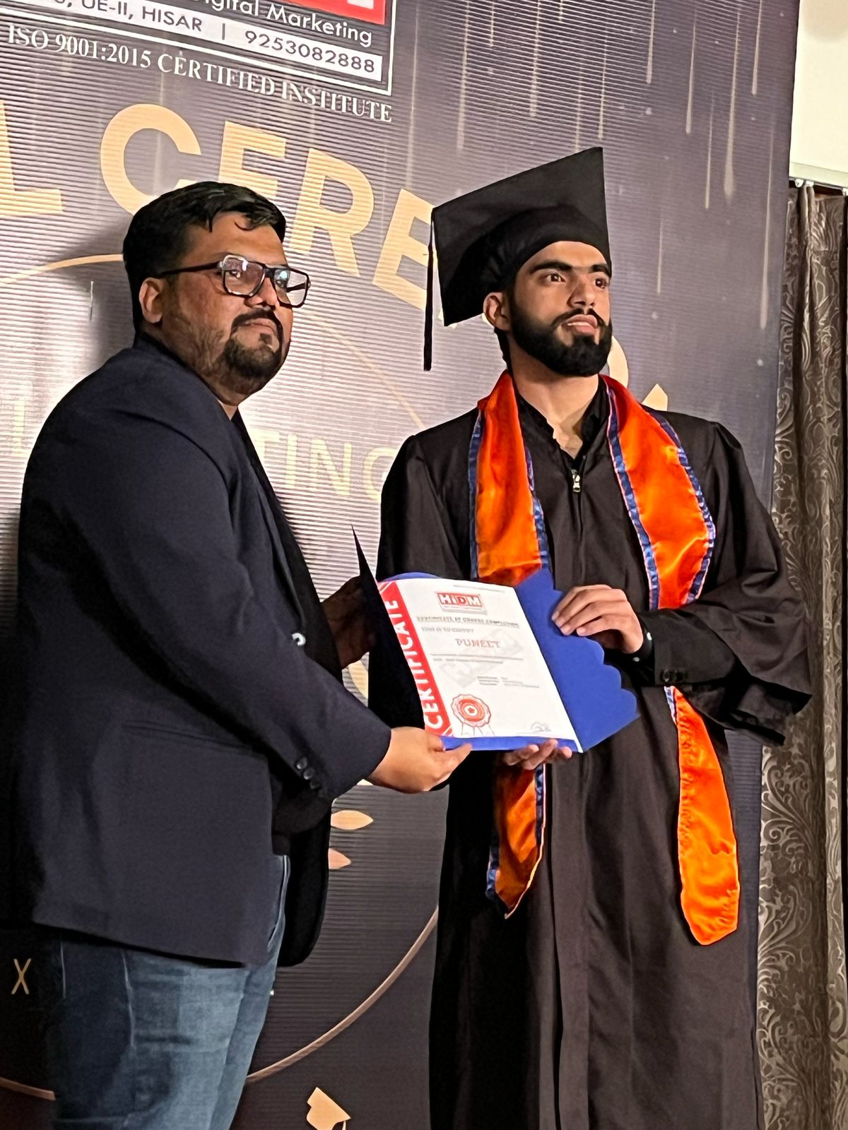 HIDM student showcasing certificate with pride.