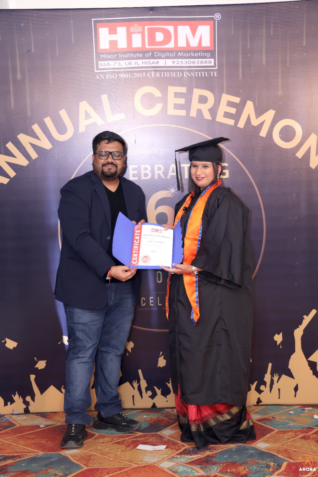 HIDM student posing with certificate and big smile.