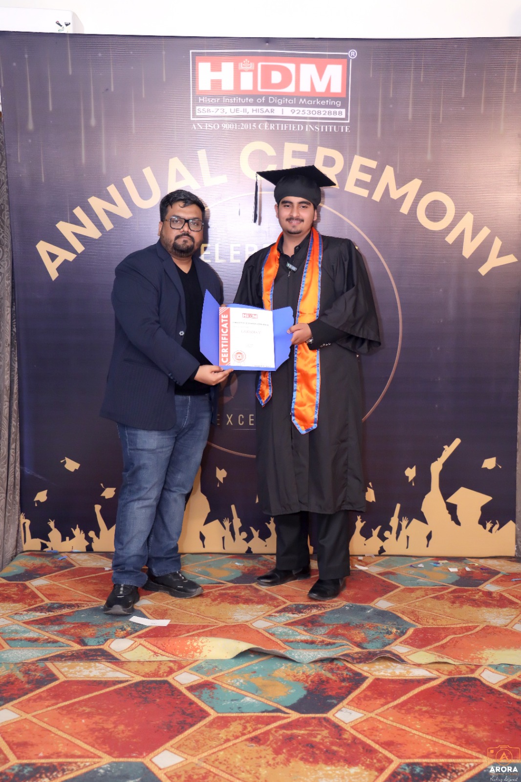 HIDM student celebrating achievement with certificate.