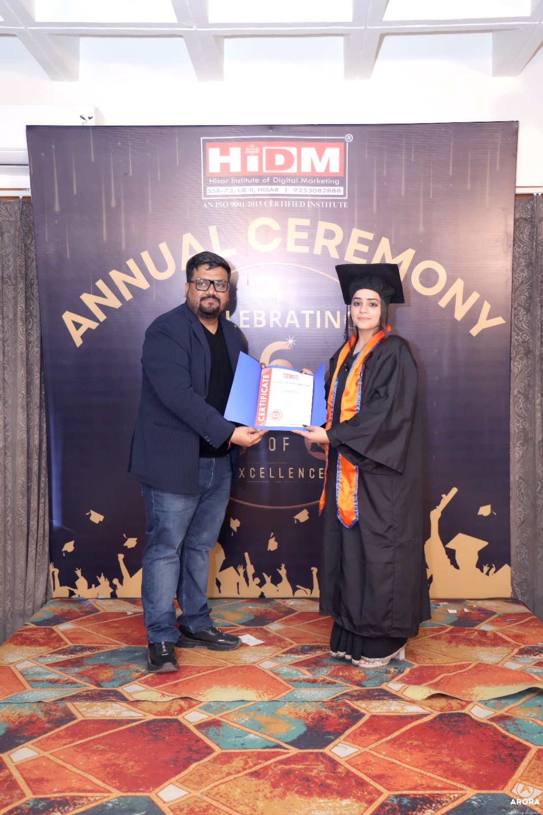 Excited student holding certificate at HIDM Annual Ceremony.