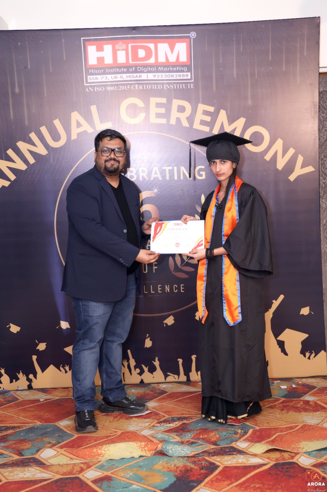 Joyful student holding certificate at HIDM celebration.