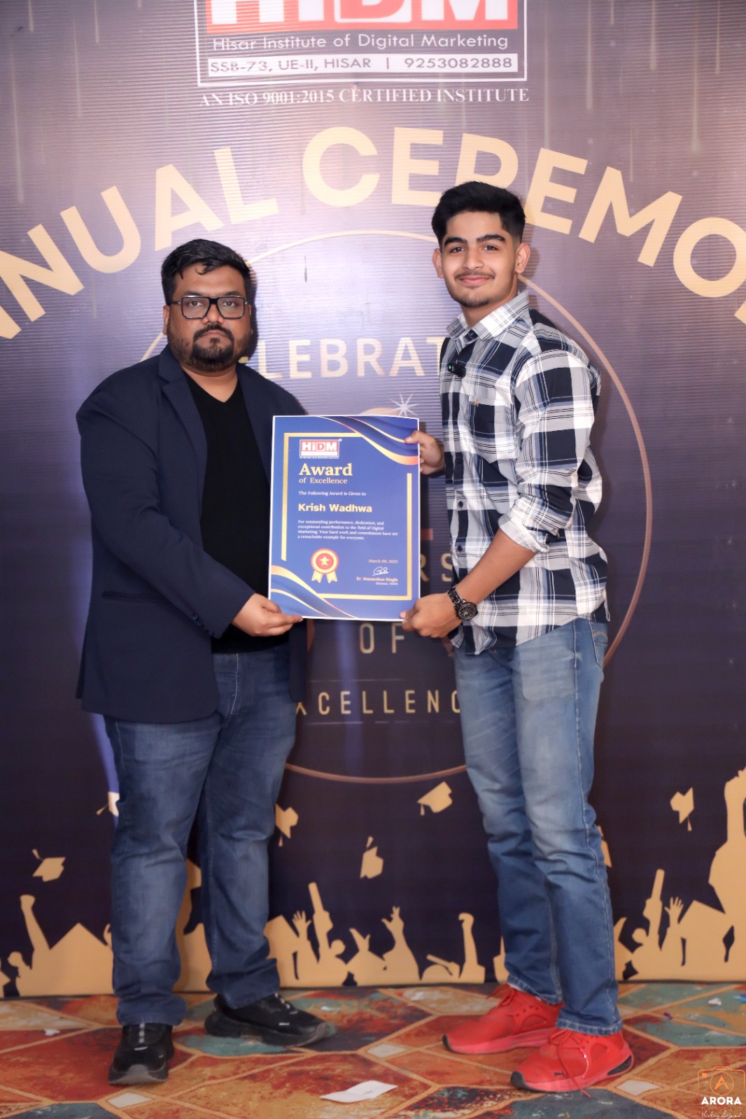 Happy student displaying Digital Marketing Excellence Certificate at HIDM event.