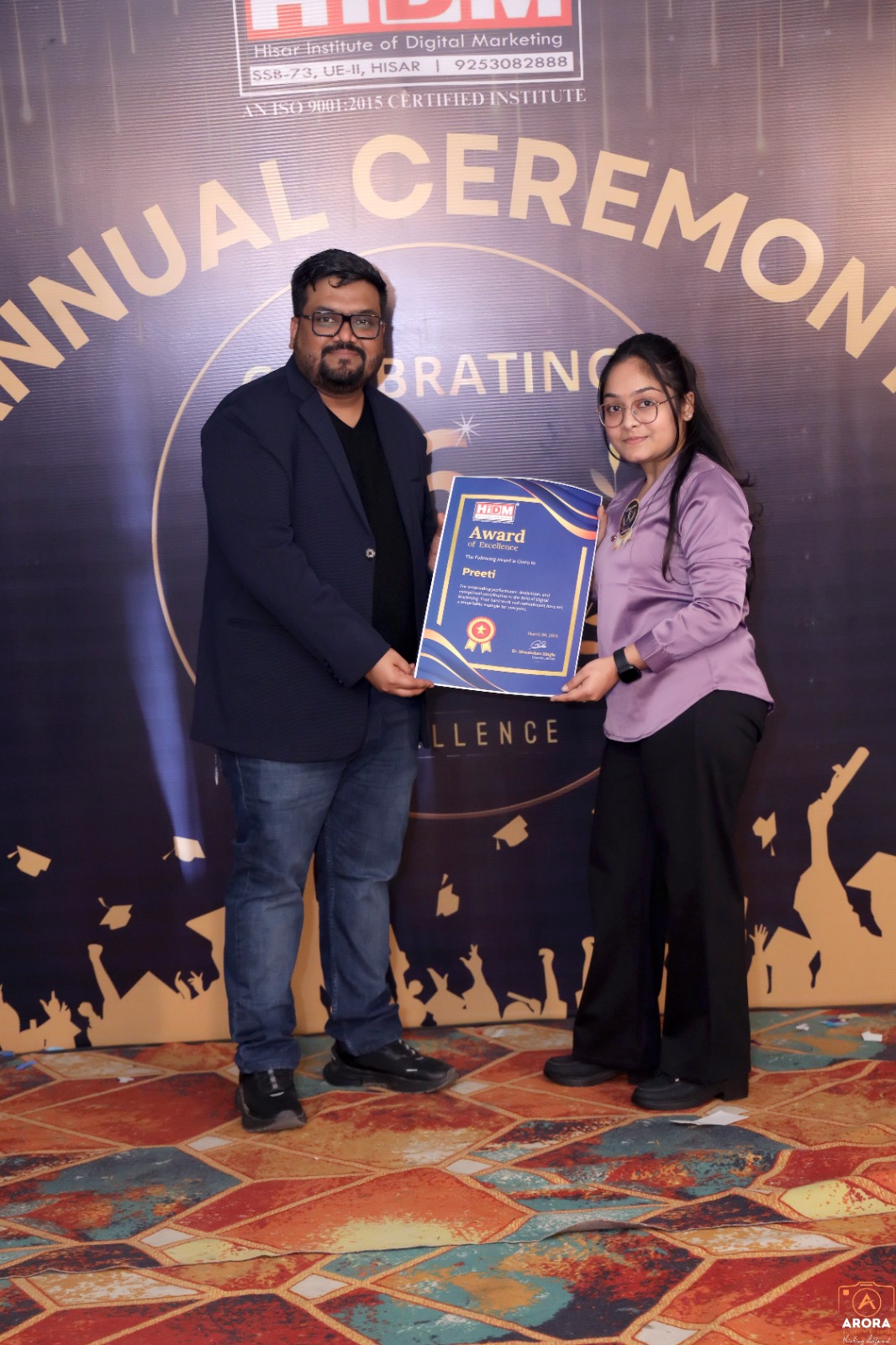 Proud HIDM student holding Digital Excellence Award certificate.
