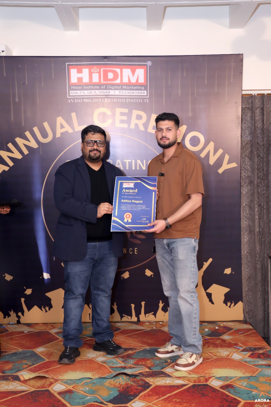 Student proudly holding Digital Marketing Excellence Certificate at HIDM ceremony.