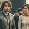 Emraan hashmi and Disha Patani standing together at a public event, with other people in the background